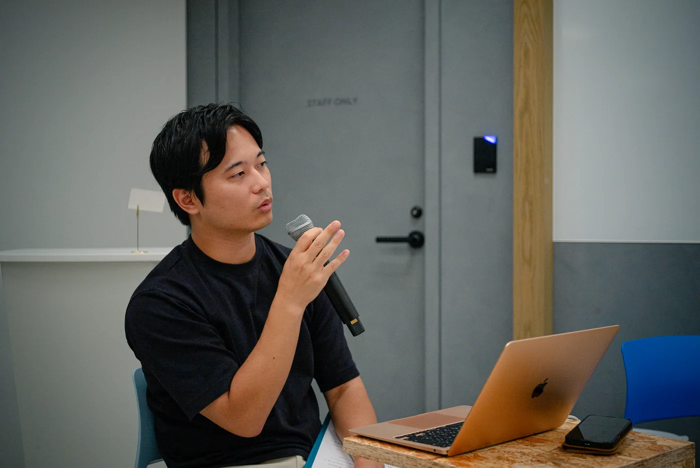 Speaker presenting with a laptop at an LR event