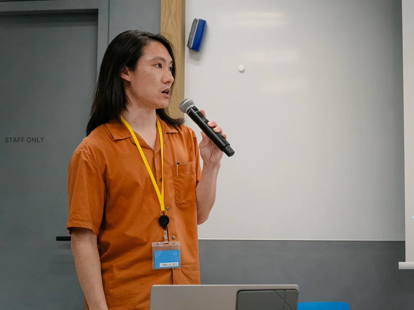 Speaker presenting beside a screen at an LR event