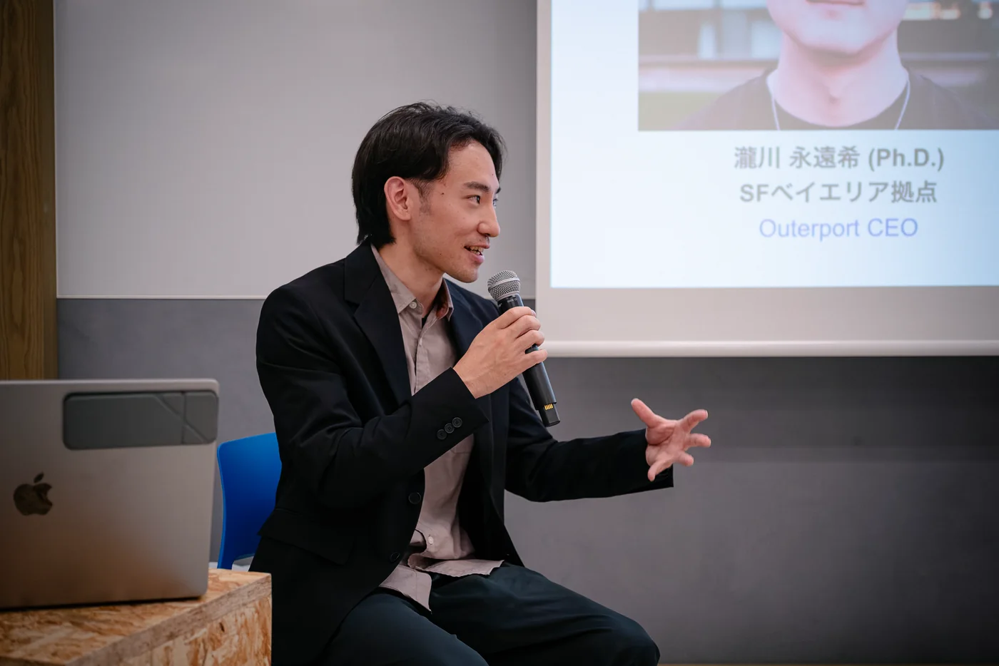 Panel speaker talking with a laptop at an LR event