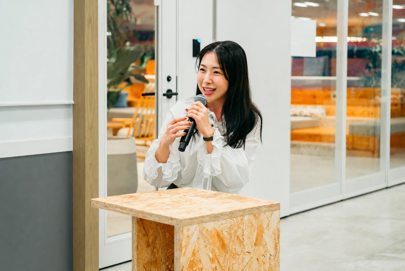 Speaker smiling with a microphone at an LR event